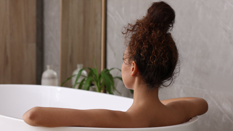 Woman relaxing in bath tub